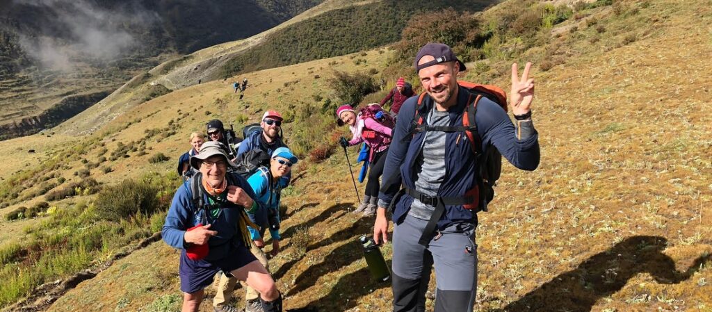 A group of wearing bags and standing on mountain